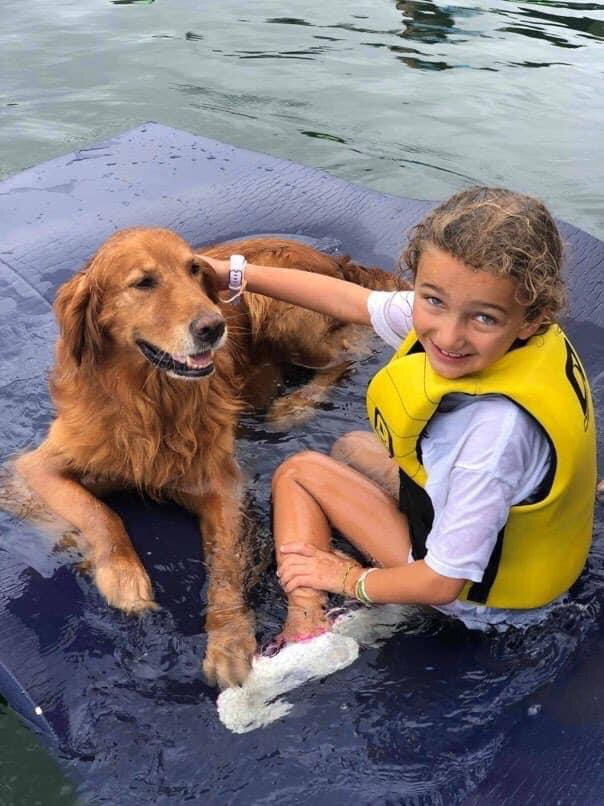 Girl and dog in lake